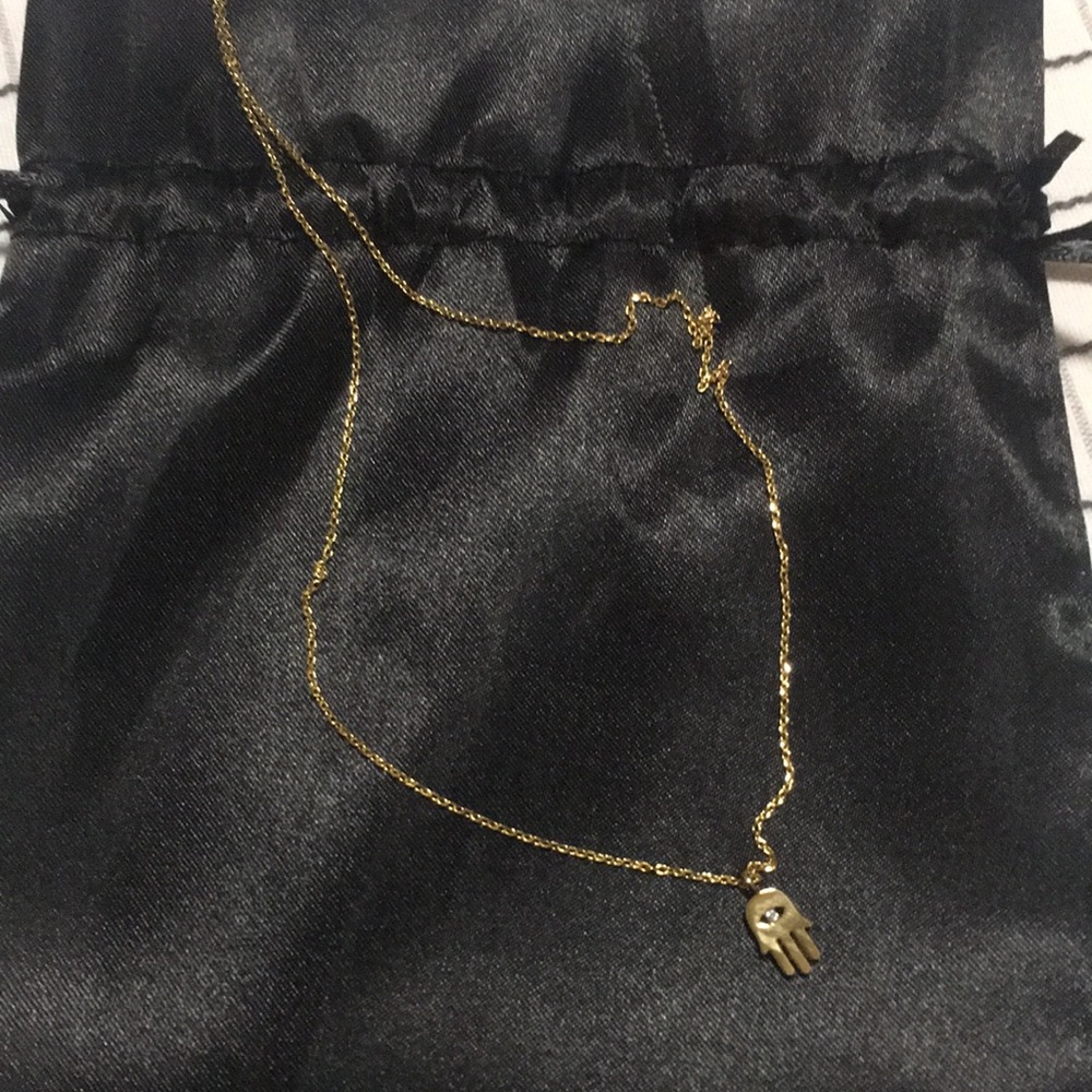 A gold necklaces Hamsá